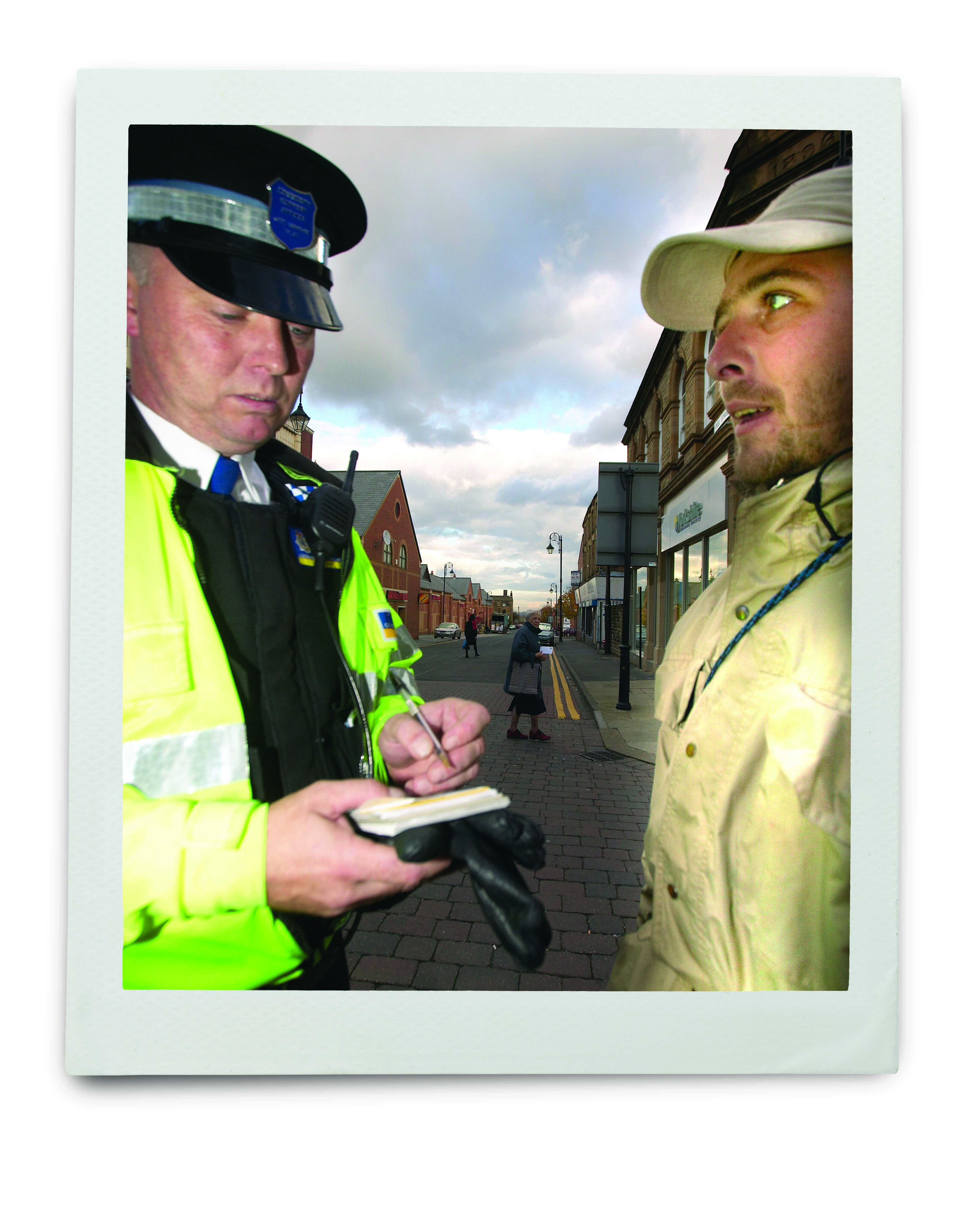 An image of a policeman and member of the public facing each other