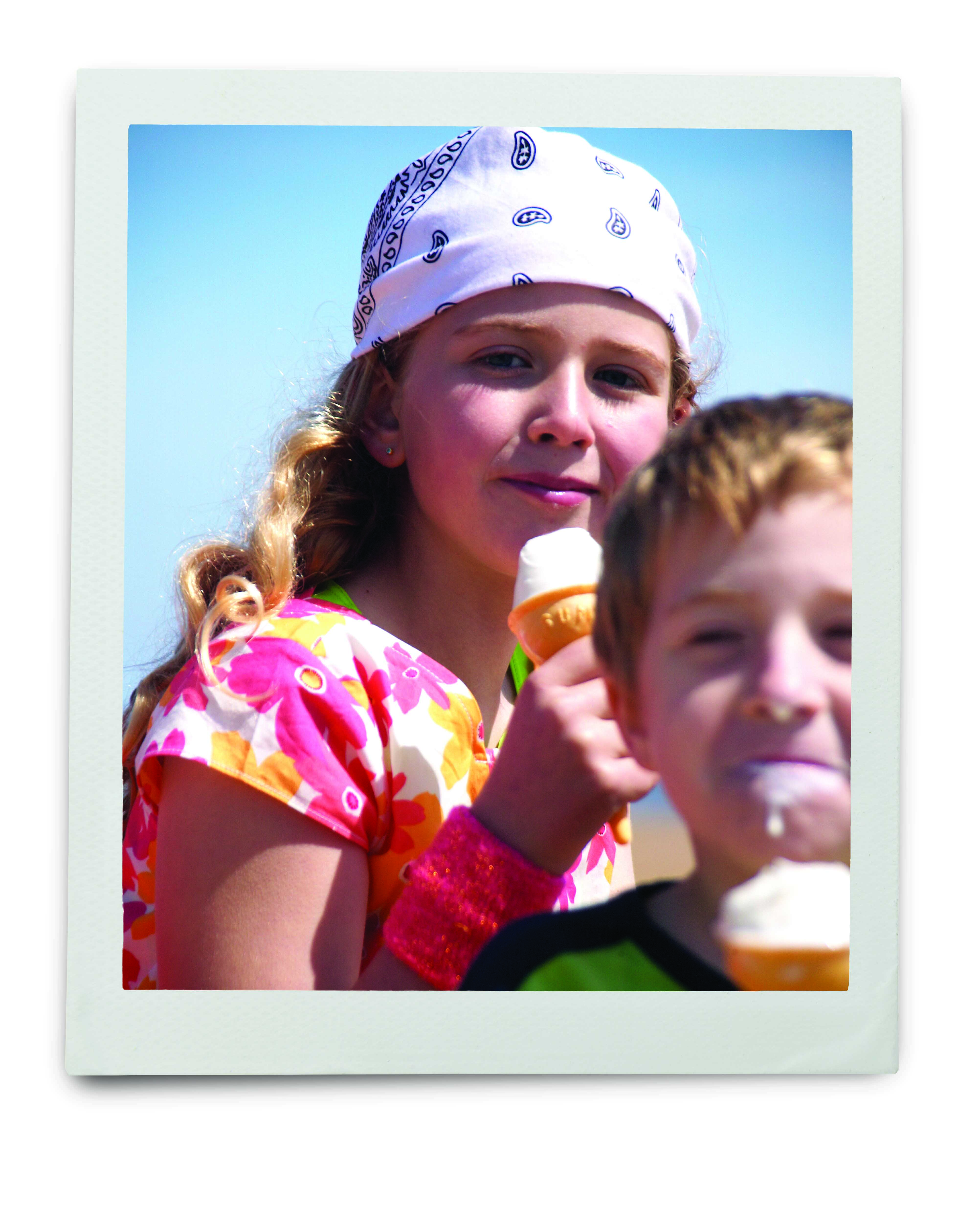 An image of a young girl and boy eating ice cream