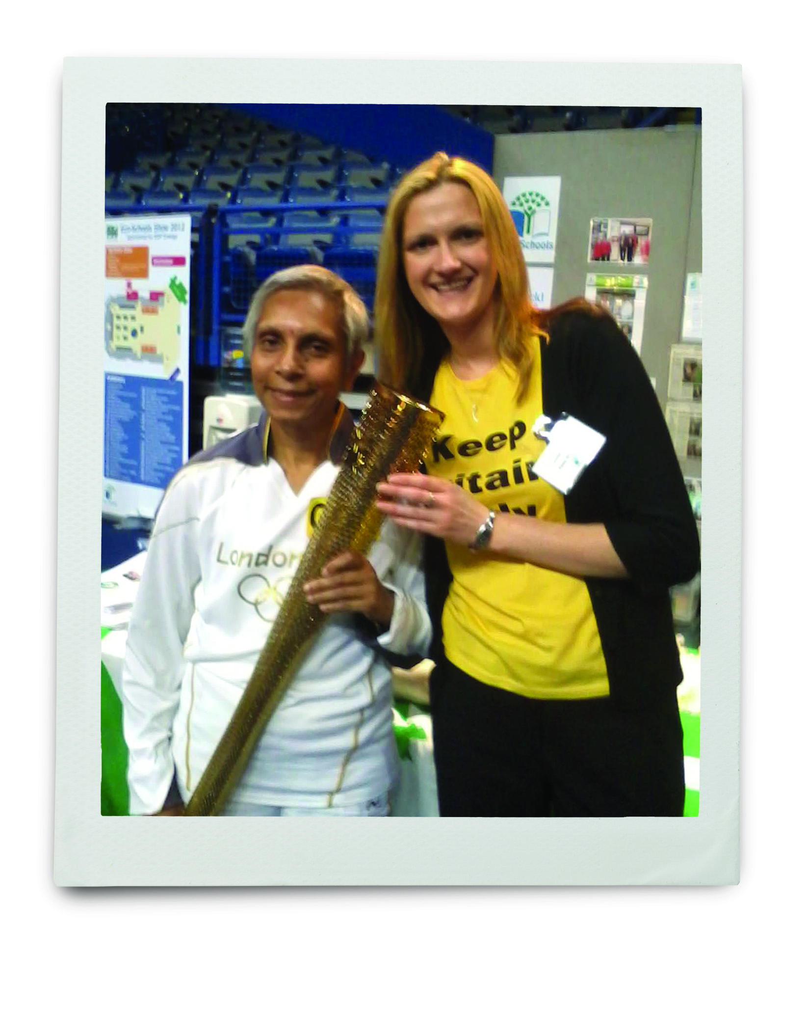 An image of a Keep Britain Tidy volunteer with someone carrying the Olympic torch 