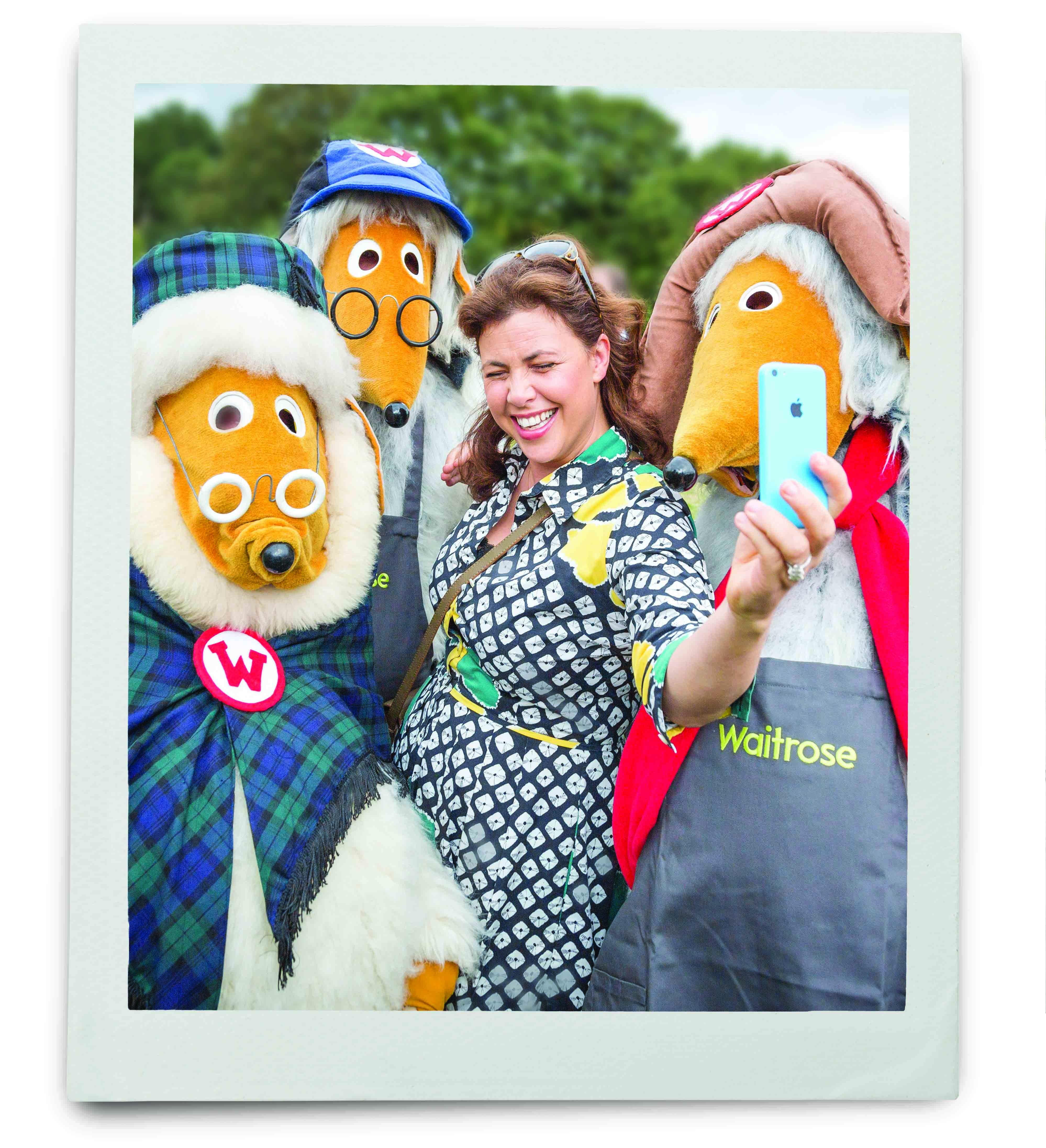 An image of Kirsty Allsop taking a selfie with three people in Wombles costumes