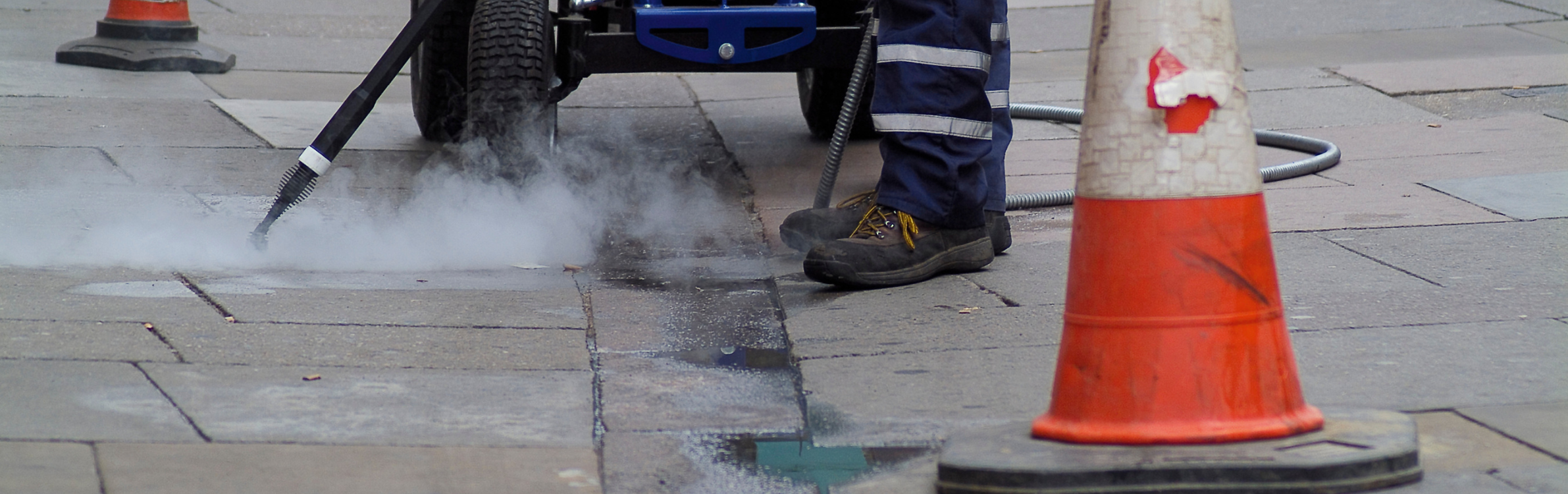 A street cleaner works to clean up chewing gum litter