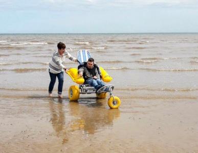 An image of a gentleman using a beach wheelchair