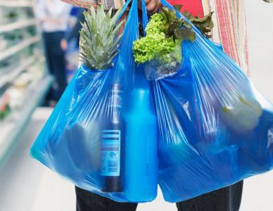 An image of plastic shopping bags full of groceries