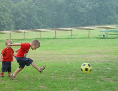 Children playing football in the park