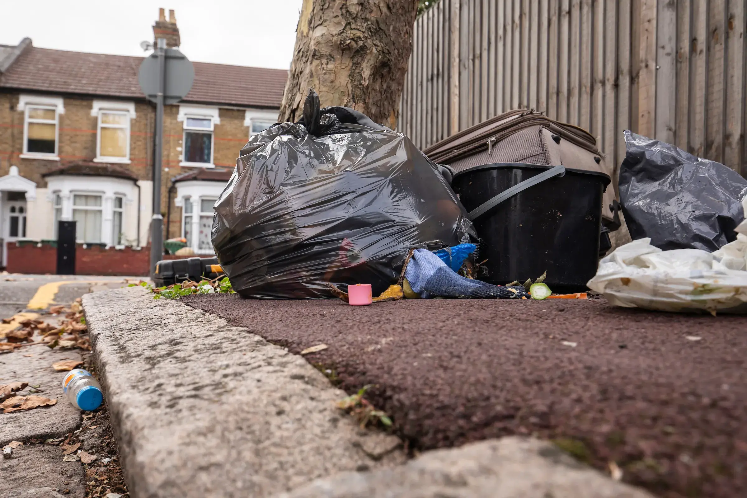 Fly-tipped household items on a residential street