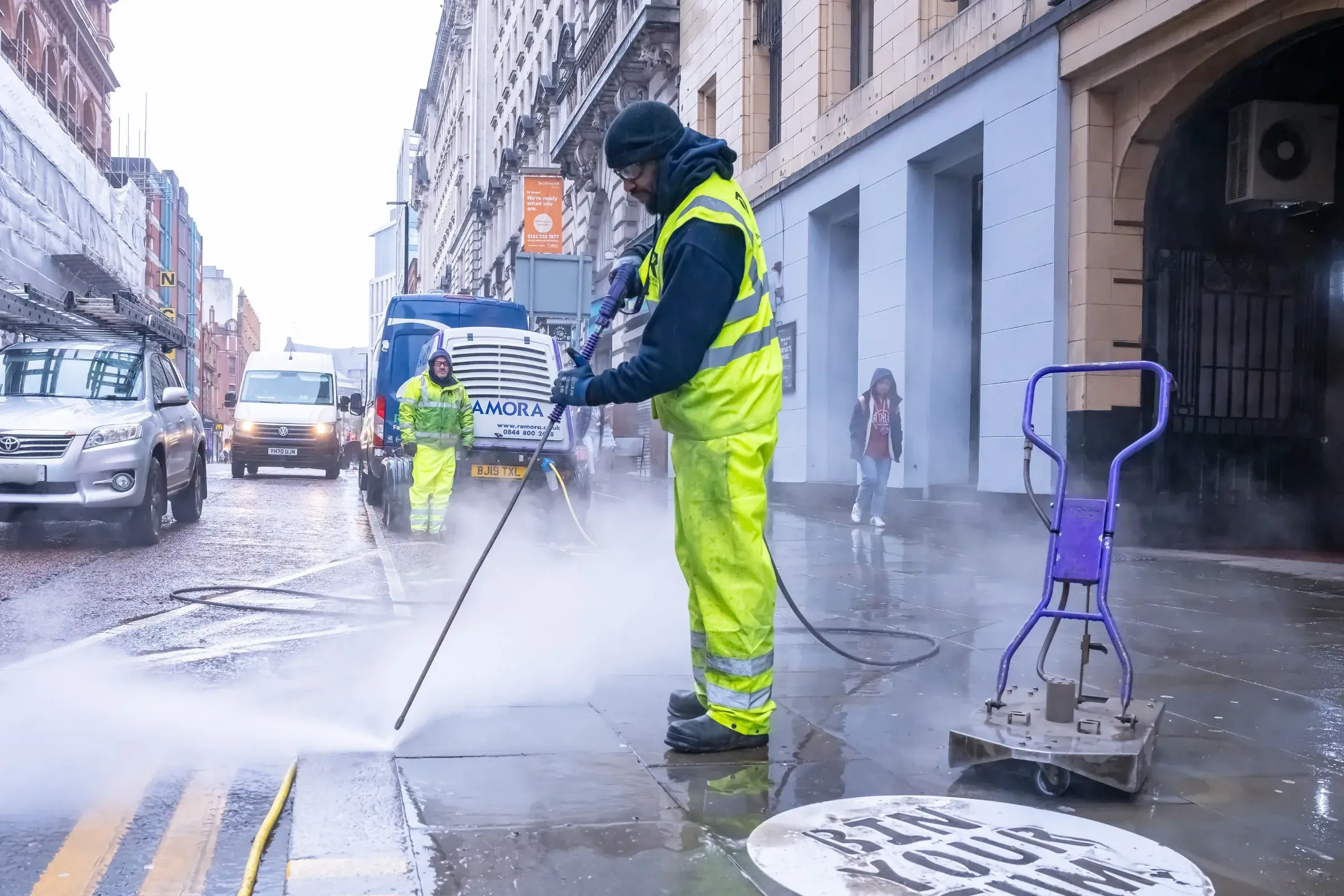Council contractors cleaning gum of street pavements
