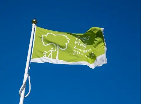 Green Flag Award flying against blue sky