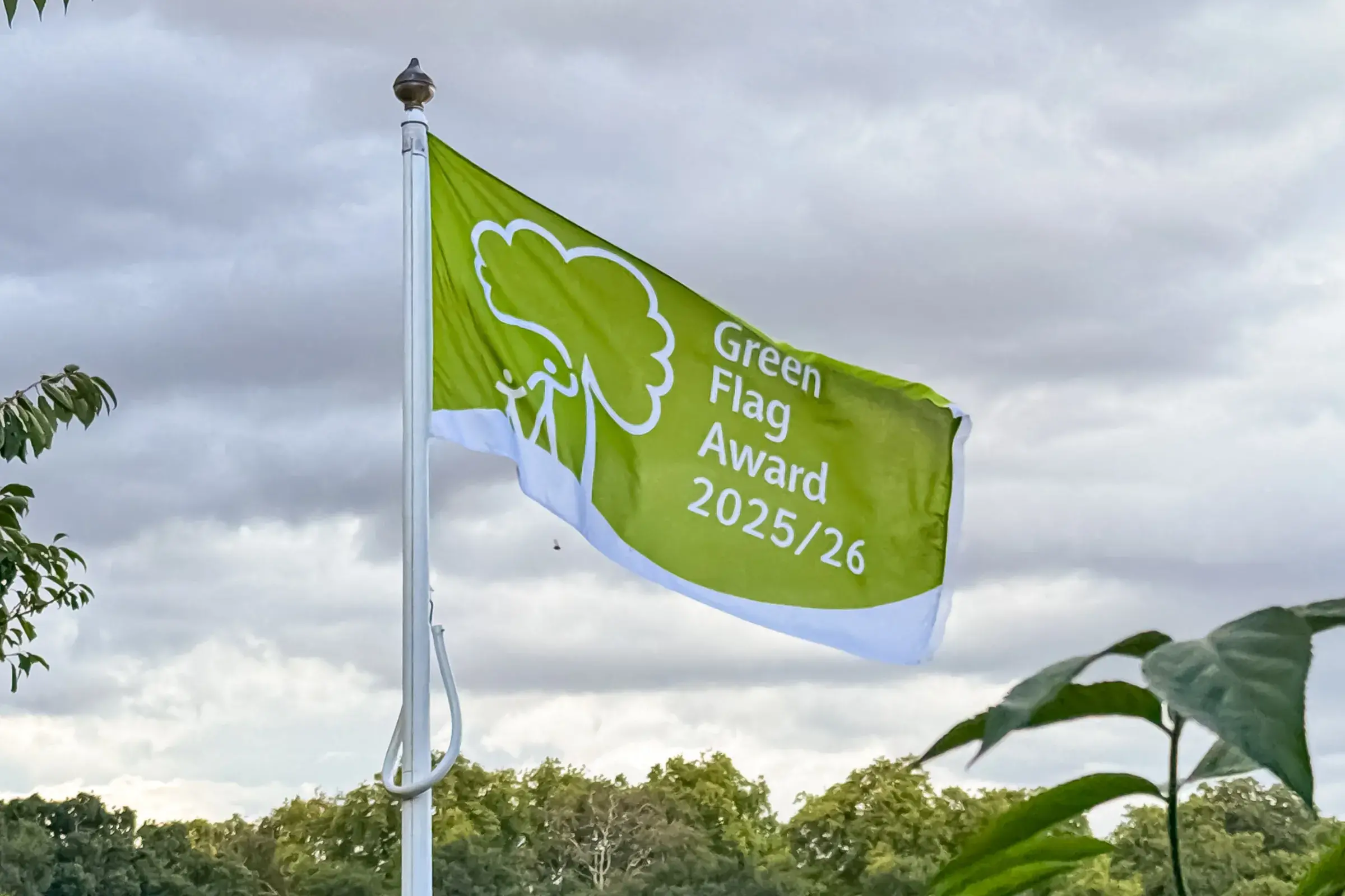 Close-up of a Green Flag Award flag flying from flag pole in a Green Flag Award-winning park