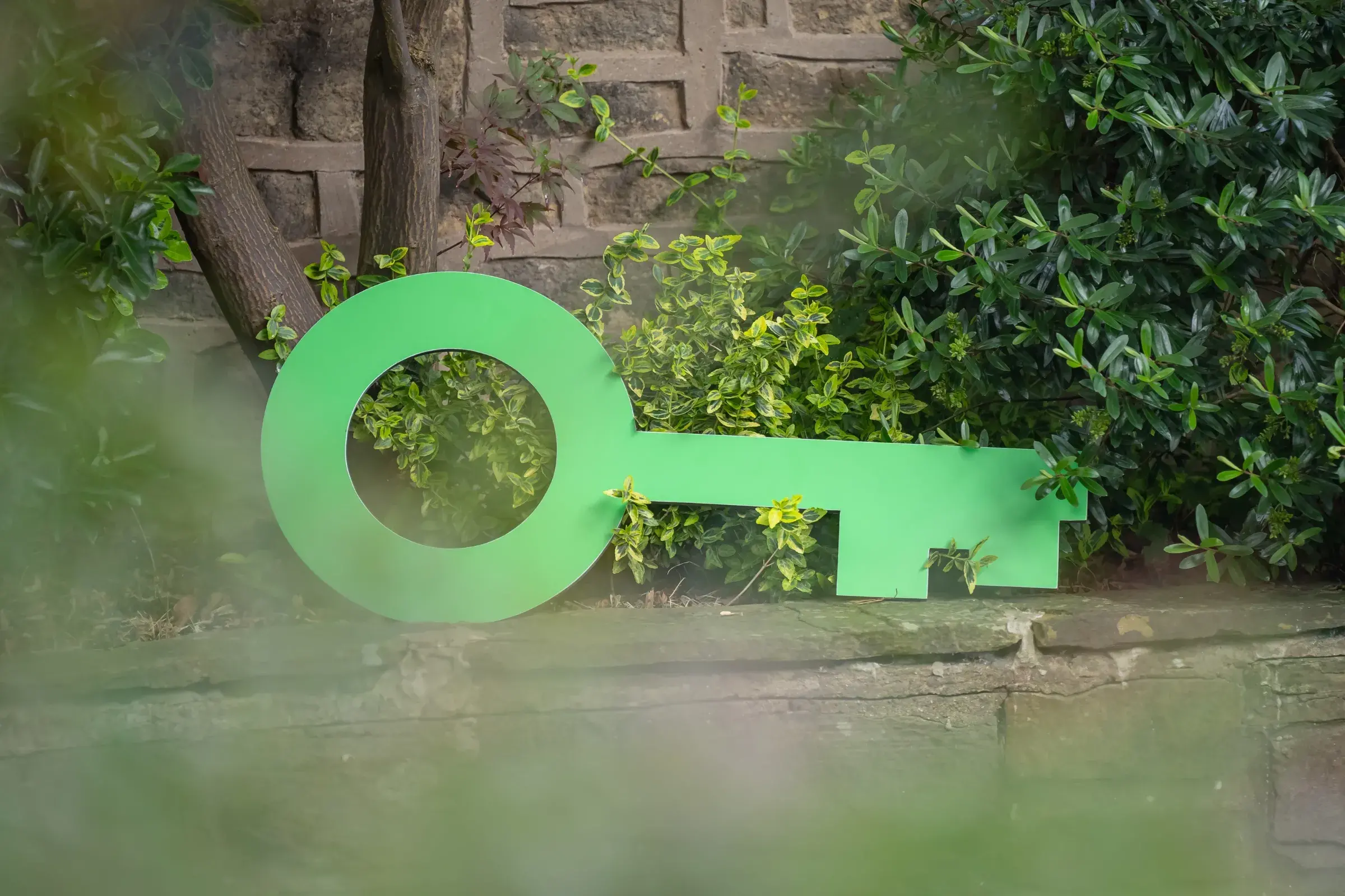 Large Green Key sitting on a garden wall at an accredited hotel