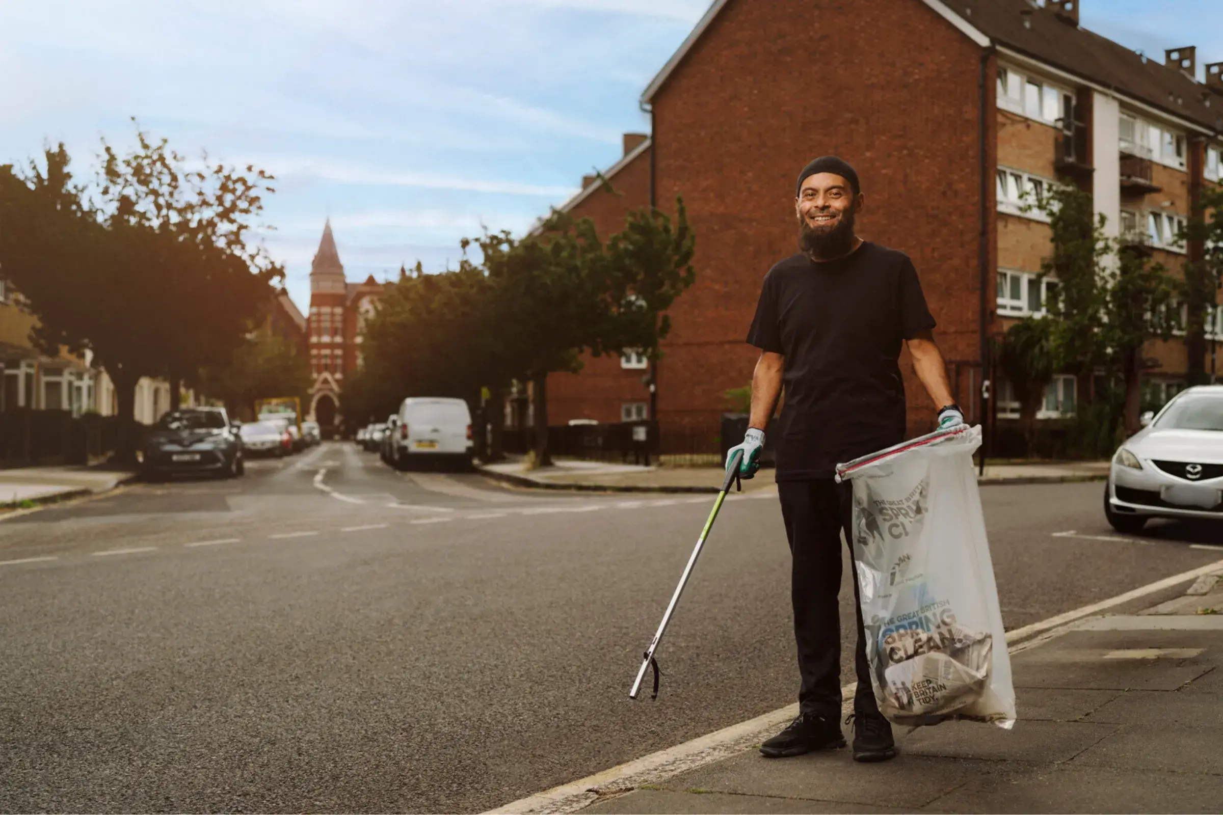 Litter Hero picking litter on residential city street