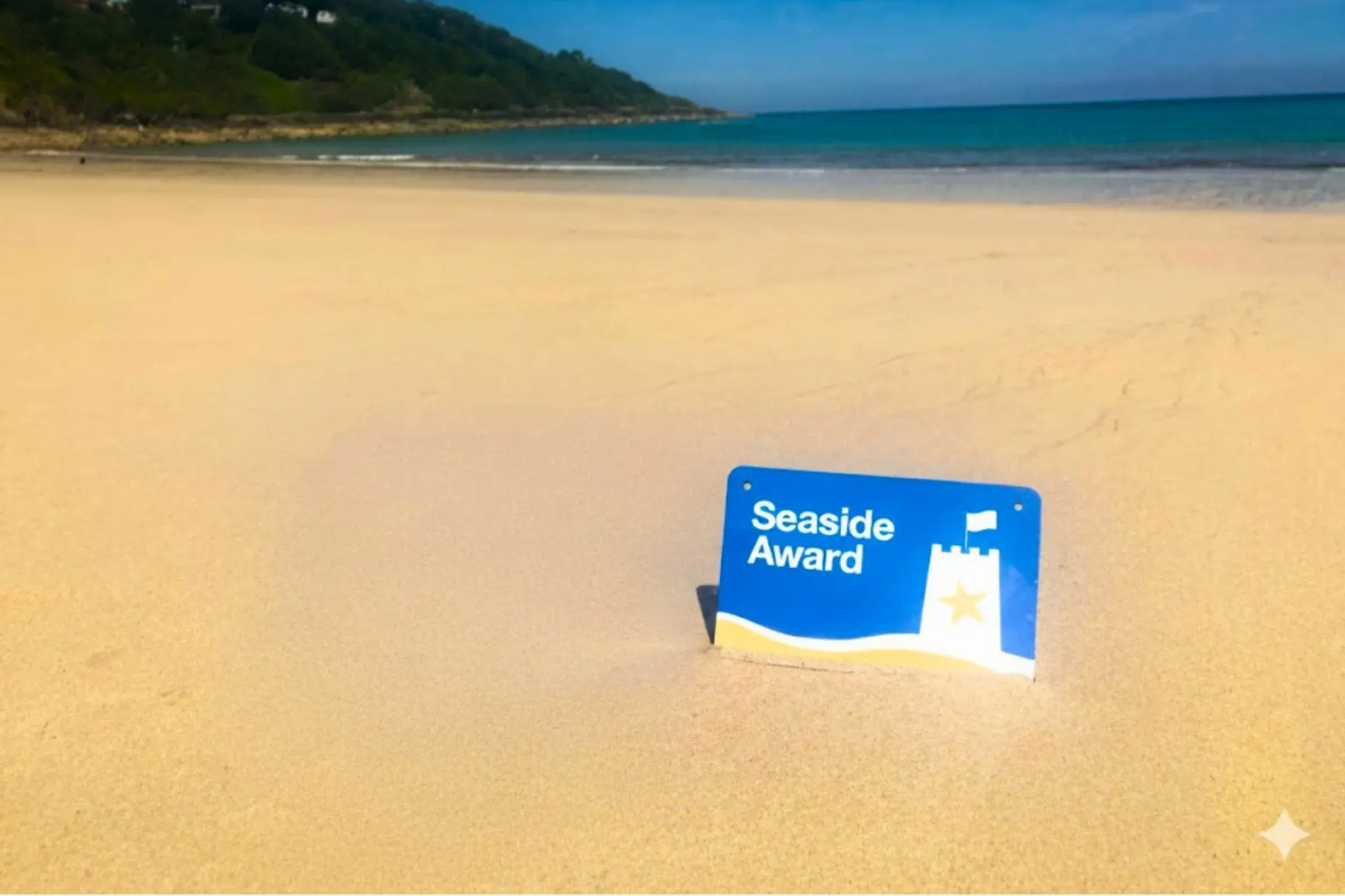 Seaside Award plaque on a sandy beach
